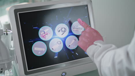 beautician touching device screen choosing mode rejuvenation procedure close up.