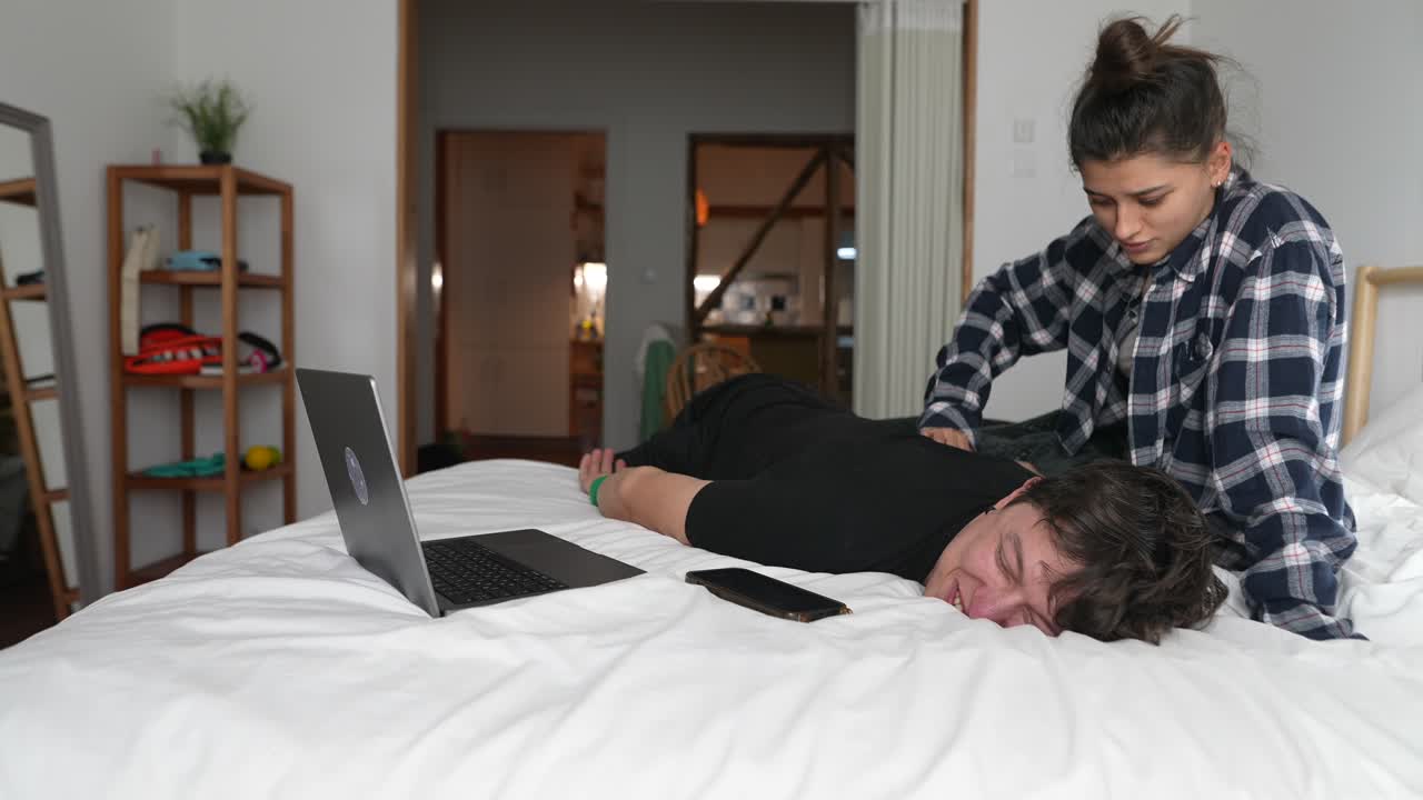 Woman Massaging Man in Bed