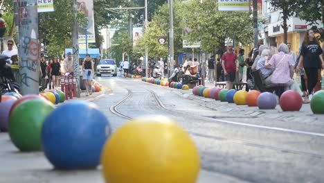 colorful pedestrian street with tram tracks and people