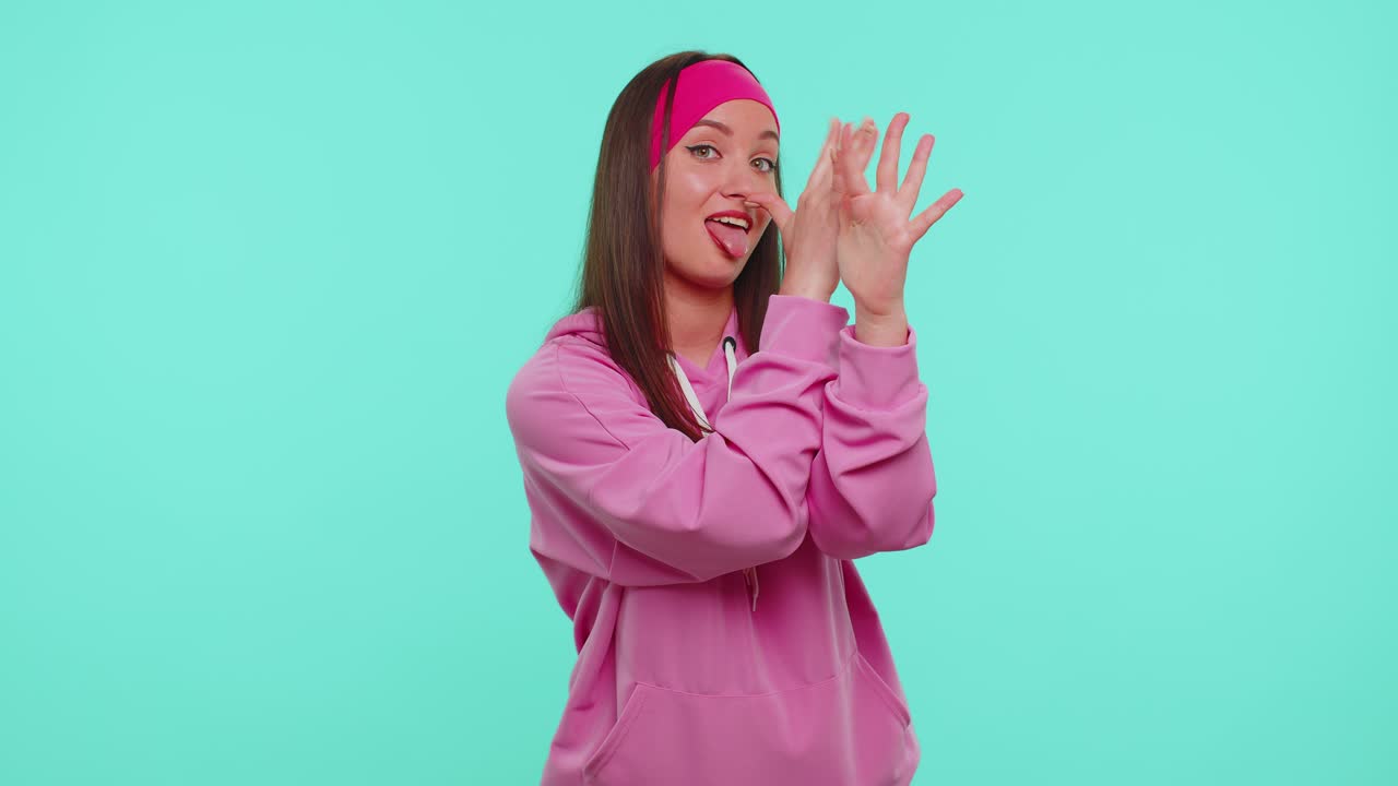 Funny teen girl making playful silly facial expressions and grimacing fooling around showing tongue