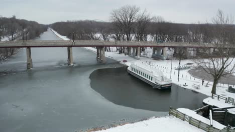 Flying-away-from-small-touristic-boat-in-frozen-river