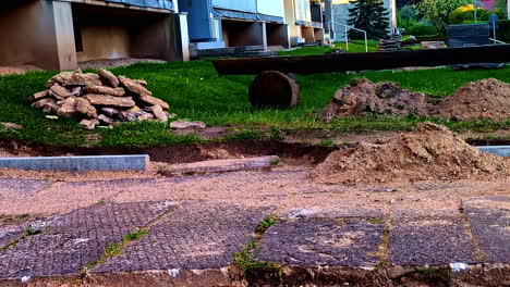 urban construction zone with piles of rubble, dirt mounds, and concrete paths