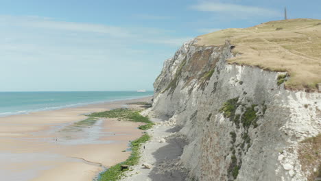 Aerial-alongside-White-Cliff-with-Ocean-view-with-beautiful-Blue-Sky-in-France,-Cap-Blanc-Nez