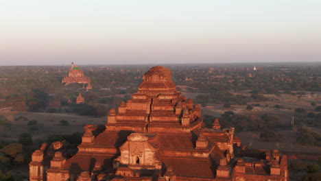 dhammayangyi temple illuminated by the red colored sunlight on a clear day