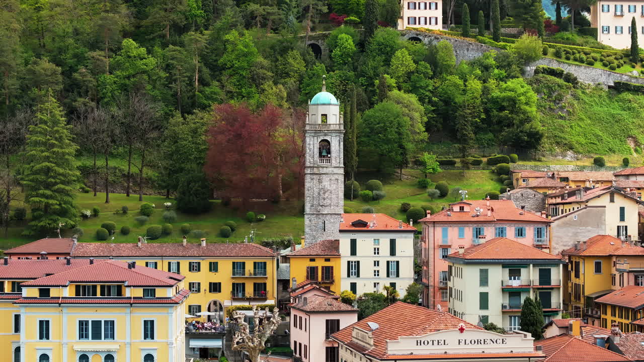 Aerial drone view of the Basilica of St. Giacomo surrounded by houses in Bellagio, Italy