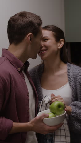 couple kissing in the kitchen