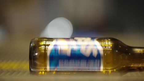 a bear bottle rotating on the escalator closeup at the bottom