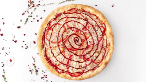 round fresh pizza with onion, pepper, vegetables, meat, red spiral sauce rotates on a white table, top view, copy space. seamless looping animation