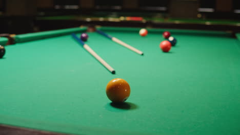 pool table with balls and cues