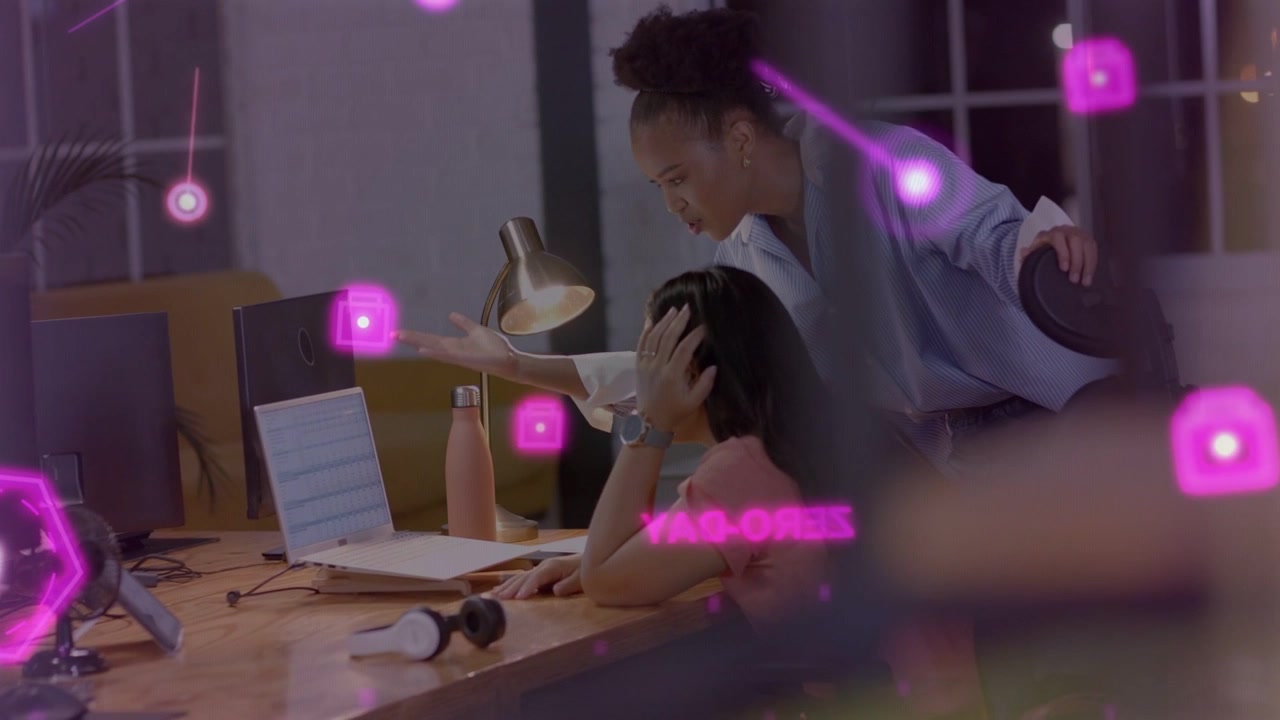 Business manager leaning pointing at laptop urging staff typing for training pink overlay over desk