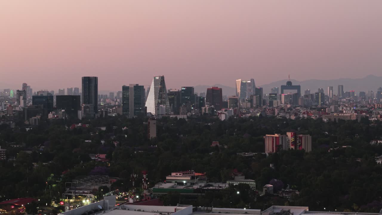 Aerial drone view of a reddish sunset above the polluted Mexico City.