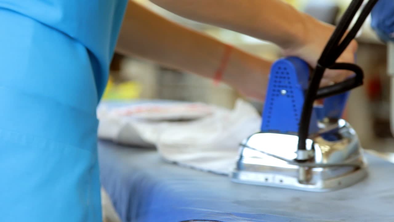 mujer trabajadora de hierro de tela. mujer trabajando en un taller de tejido