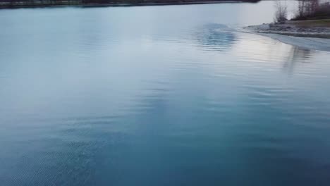 the drone turns fast around over a lake in switzerland