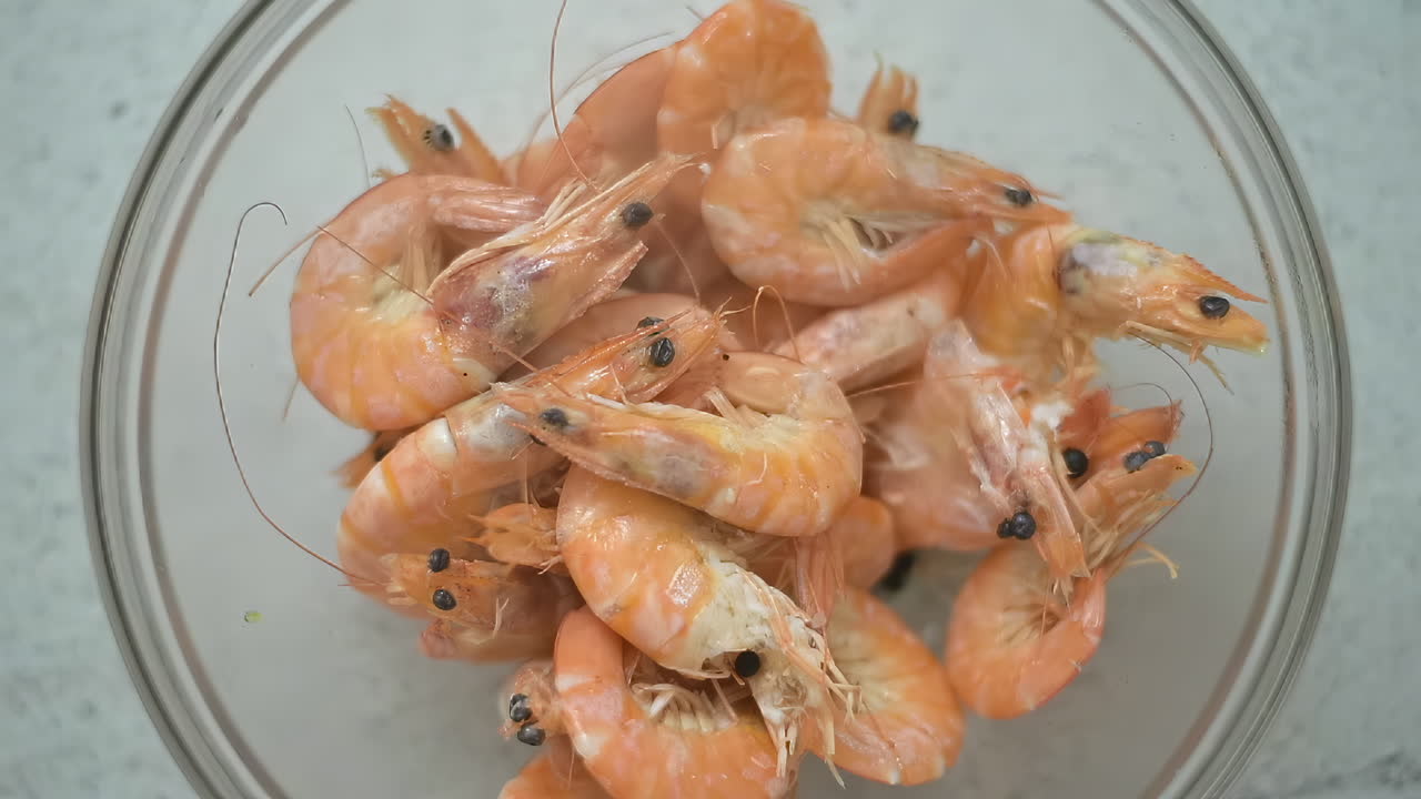 Close up of steam coming out of a bowl with cooked shrimp