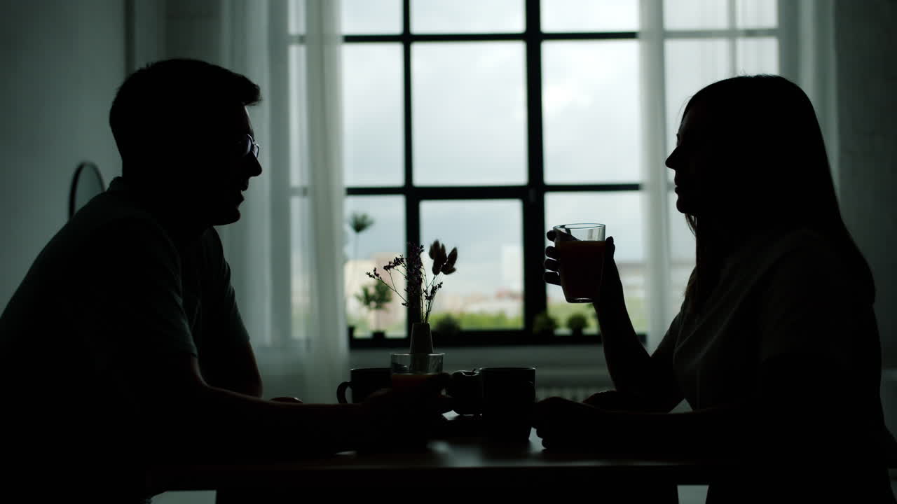 Couple Having Breakfast in Front of a Window