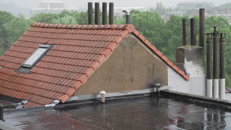 heavy rain pouring down on roofdeck of a house with concrete tile roofing