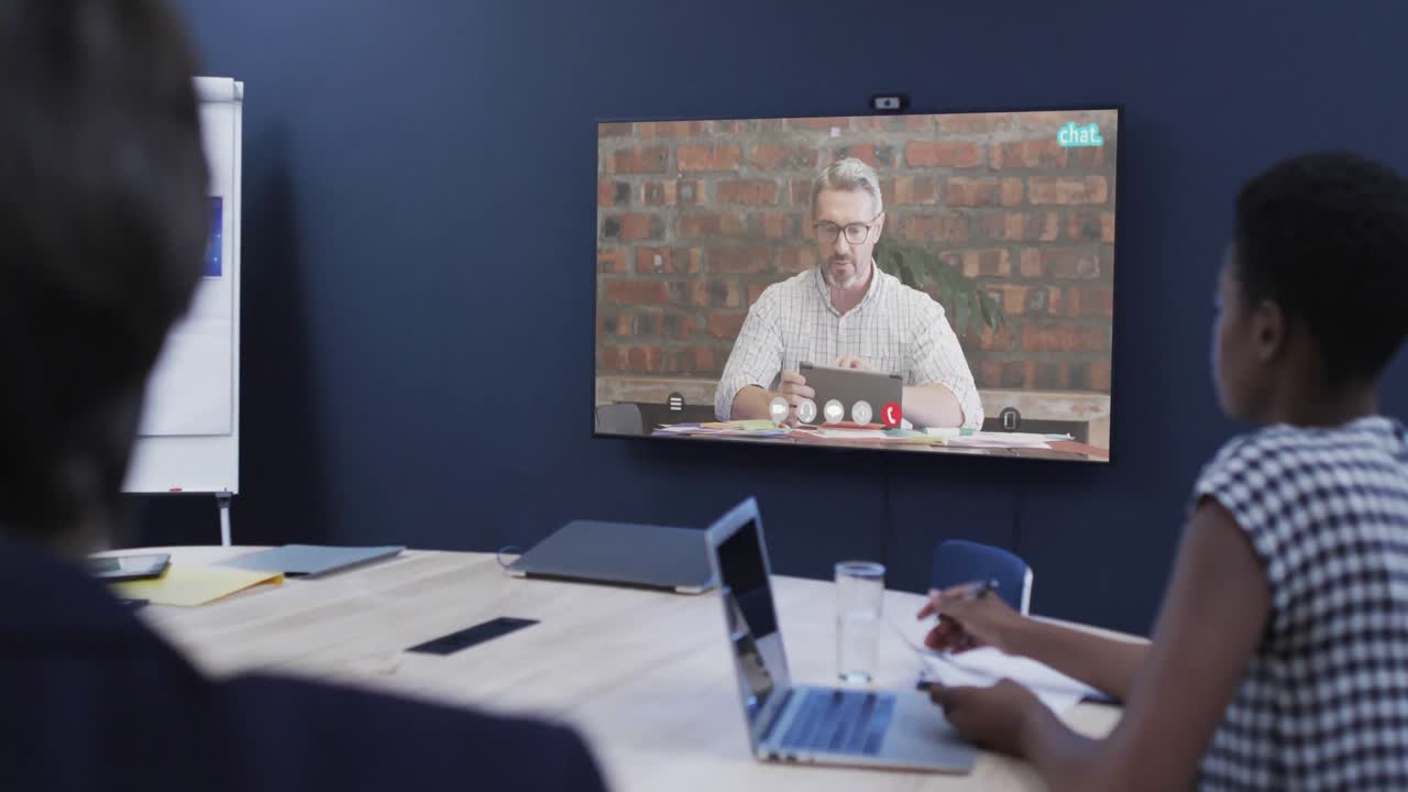 Diverse business people on video call with caucasian male colleague on screen