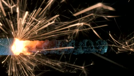 christian sparklers, bengal lights on black background. firework sparkler burning on dark background. closeup