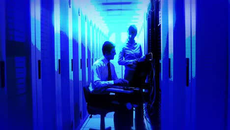 animation of blue shade over caucasian workers in server room