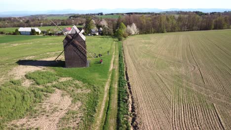 Nové-Dvory,-Bílovec,-Nový-Jičín-District,-Czech-Republic---A-Vintage-Windmill-Stands-Tall-Amidst-the-Peaceful-Rural-Scenery---Aerial-Drone-Shot