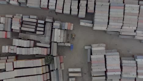 Aerial-Birds-Eye-View-Of-Dirty-Dusty-Stacked-Cargo-Containers-At-Storage-Site-In-Karachi