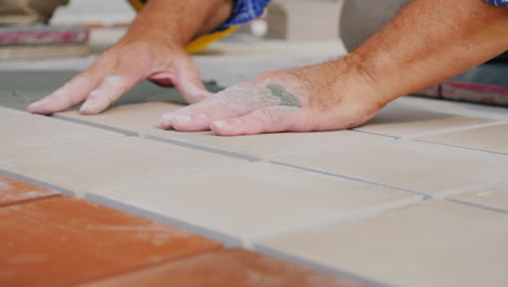 Workers-Laying-Tile-On-The-Floor-Close-