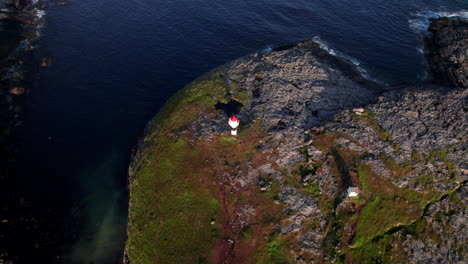 Colorful-lighthouse-with-a-scenic-landscape-around-in-Northern-Norway-on-a-sunny-day