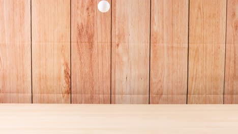 a ball bounces on a wooden surface