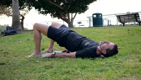 Mature-male-exercising-his-core-outdoors