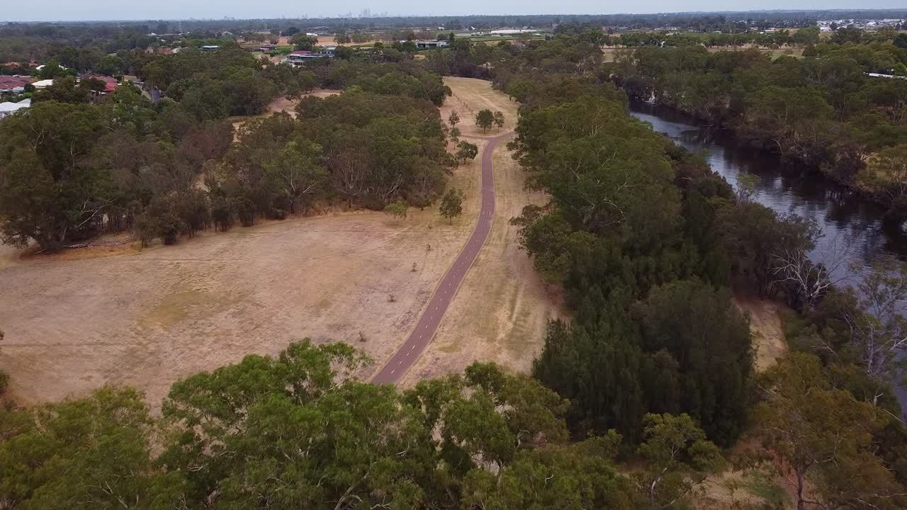 Bird&rsquo;s eye view of cycle path and footpath diverting off between trees
