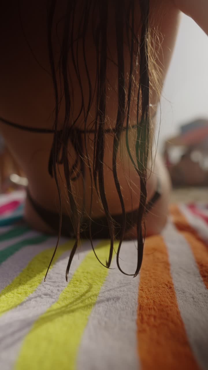 Woman on beach with wet hair