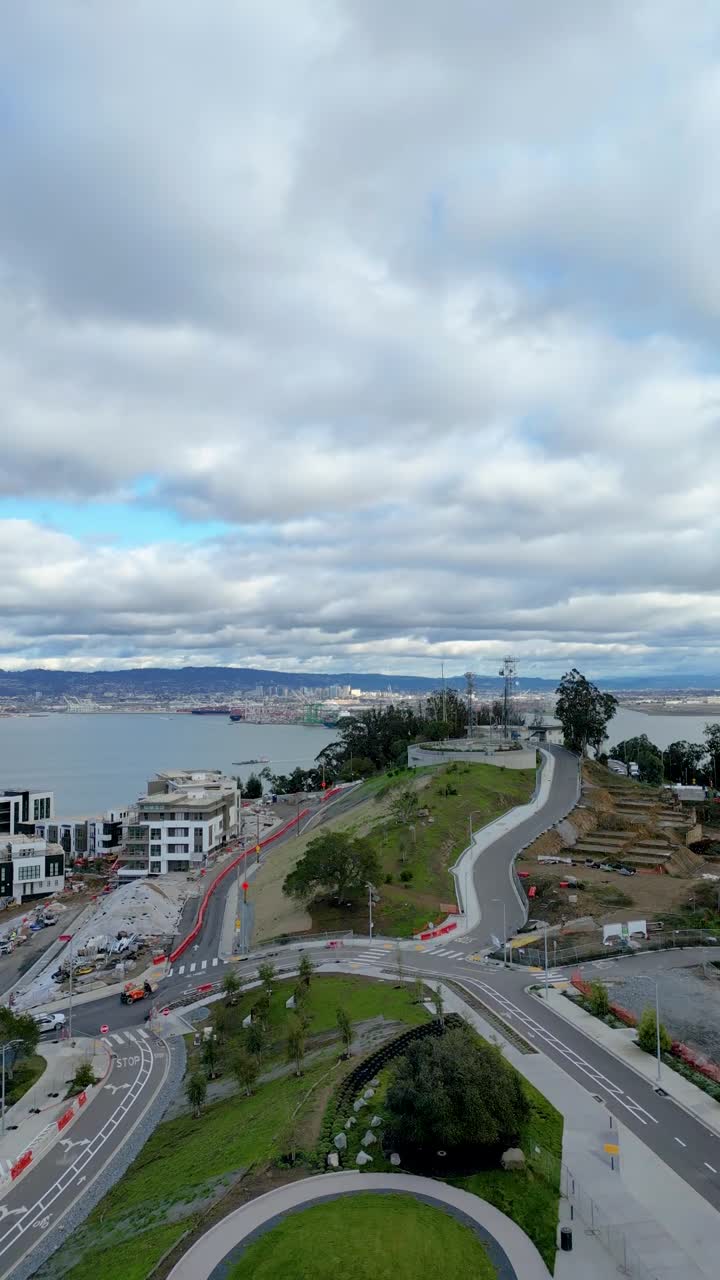 Stunning vertical drone reveal of Yerba Buena Island meeting the Bay Bridge in California, capturing breathtaking views of nature and architecture.