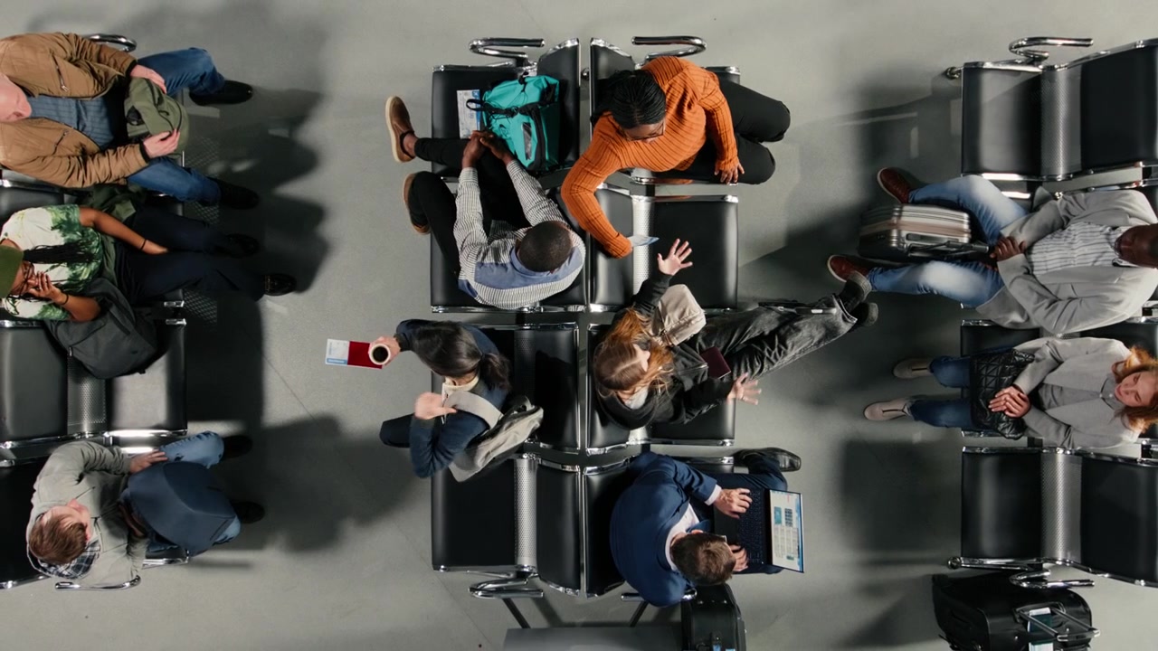 Top down view of people talking in airport hub, checking visa documents
