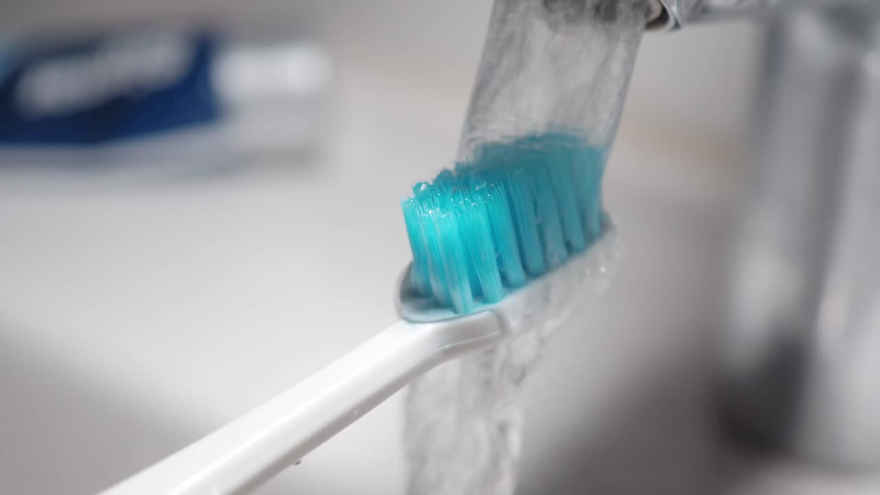 Close-up of a toothbrush under running water