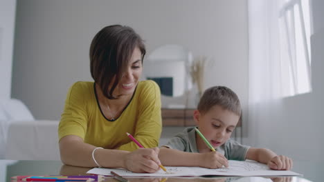 Young-Woman-And-Child-Drawing-Together-Making-Picture-With-Pencils-In-Flat