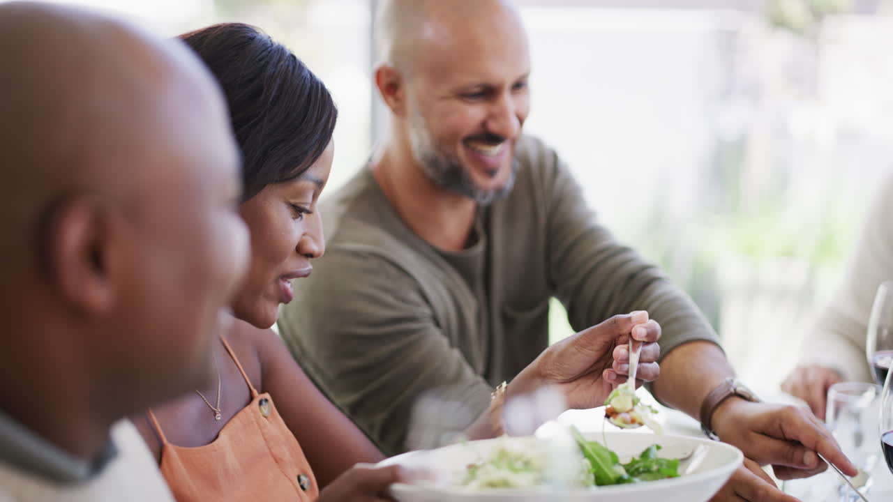 Diverse group of happy friends eating