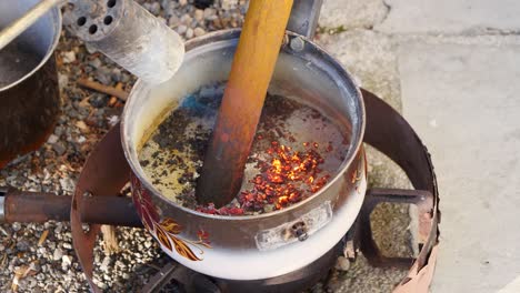 metal bar melting at an angle with torch and fire