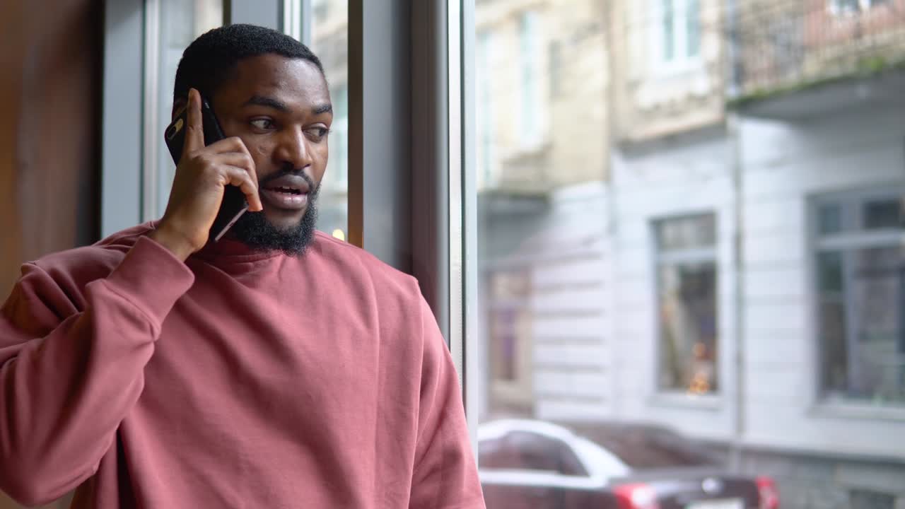 Man having busines conversation by the cellphone in the restaurant