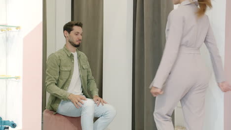 couple shopping for clothes in dressing room