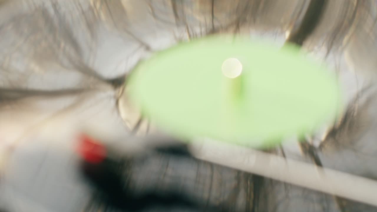Blurred Green Oval with Bright Light Reflection
