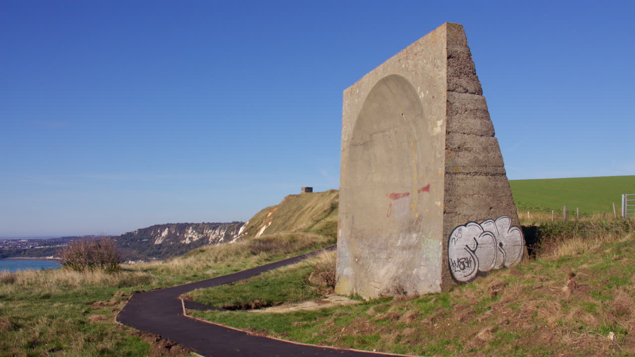 Historic Concrete Sound Mirror on a Grassy Coastal Cliffside