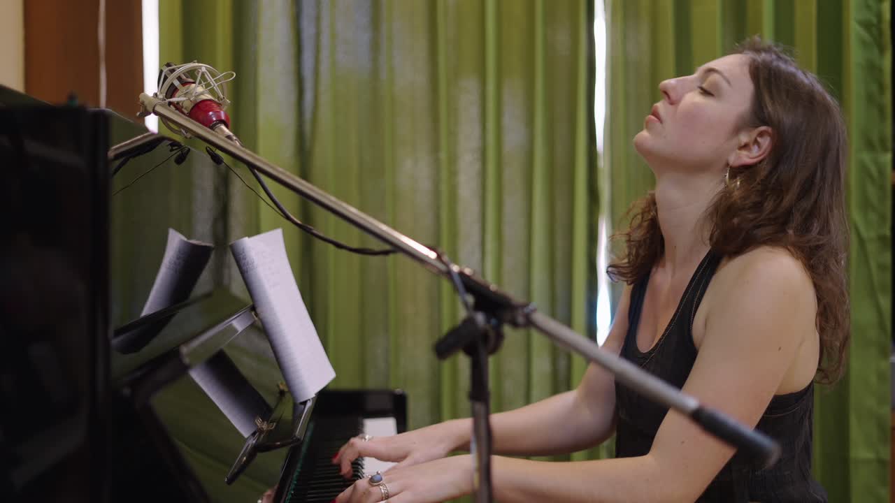 Female Musician Playing Piano in a Recording Studio