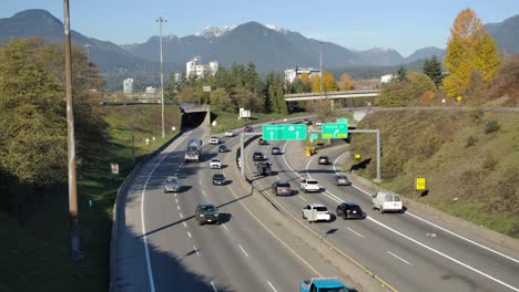 busy highway with cars near mountains on sunny day, vancouver, canada, aerial view