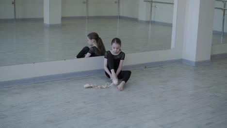 young ballet girl at studio lesson. training performance. stretching exercise pose. ballerina practice balance technique. classical elegance fitness.