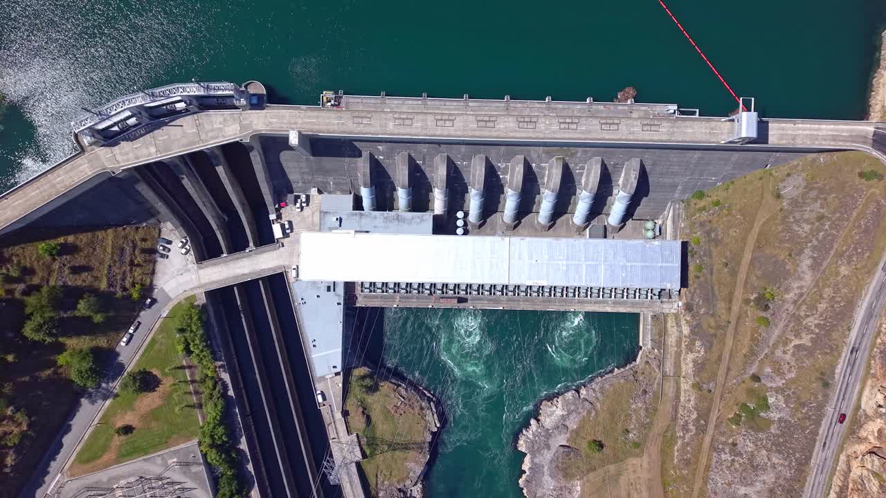 Top down and rising drone footage encaptures alternative power production facility in New Zealand. Hydro Electric dam construction on the Clutha river one of New Zealand's biggest