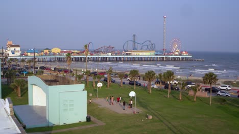 Drone-view-of-the-Pleasure-Pier-and-Galveston-Beach-in-Galveston,-Texas