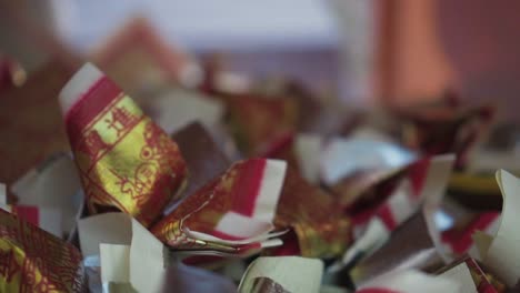 Close-Up-Shot-Of-Spirit-Money-On-Paper-Replica-Ship