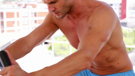 fit man working out on exercise bike