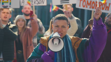 Group-Of-Protestor-With-Megaphone-Waving-Flags-On-Demonstration-March-For-Gender-Equality