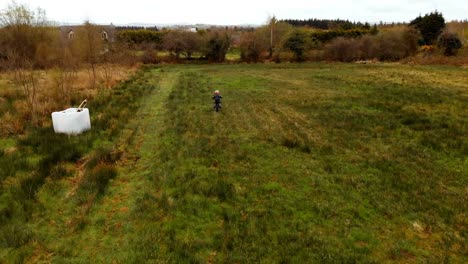 boy riding a bike in the green field 4k